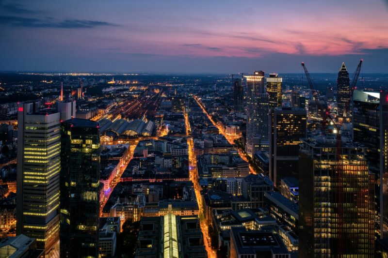Aerial view of Frankfurt's modern skyline illuminated at dusk, showcasing the vibrant urban landscape.